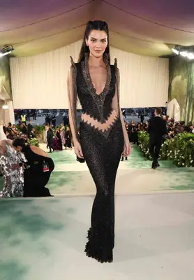 Kendall Jenner wears a black Givenchy 1999 archival look with a waistline cutout to the 2024 Met Gala