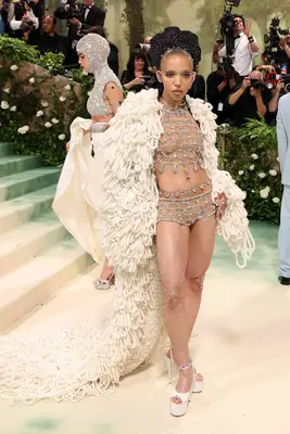 FKA Twigs wears a dazzling Stella McCartney set with a loop fabric cape and platform shoes to the 2024 Met Gala