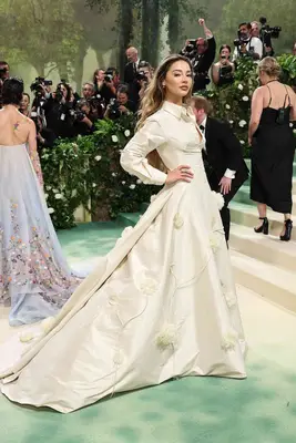 Madelyn Cline wears a white gown with flower detailing and collar to the 2024 Met Gala