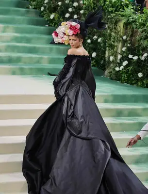 Zendaya wears a black gown and floral headpiece to the 2024 Met Gala