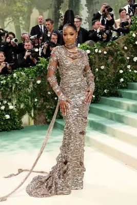 Keke Palmer wears a sparkly chrome column gown with wrapped arms and an ultra-high ponytail hairstyle to the 2024 Met Gala