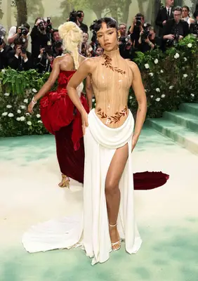 Taylor Russell wears a structured dress with a wooden bodice and white skirt to the 2024 Met Gala