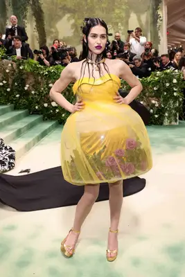 Amelia Gray wears a yellow Undercover mini dress with structured light-up skirt to the 2024 Met Gala