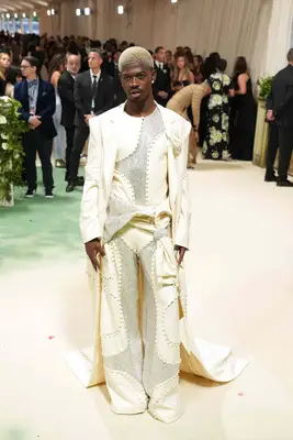 Lil Nas X wears a white three-piece Luar suit with Swarovski crystals to the 2024 Met Gala
