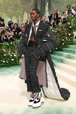 Alton Mason wears a black and white tweed suit with blanket train and platform shoes to the 2024 Met Gala