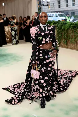 Cynthia Erivo wears a tailored Thom Browne jacket and skirt set with rose petals to the 2024 Met Gala