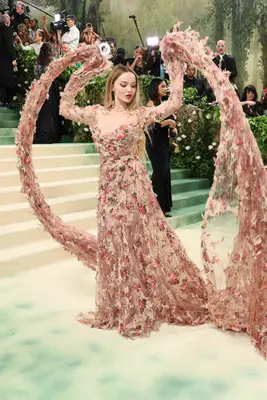 Dove Cameron wears a pink and neutral floral gown to the 2024 Met Gala