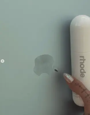 Harris Dickinson poses with Rhode Glazing Mist.