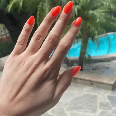 Selena Gomez with orange jelly nails 