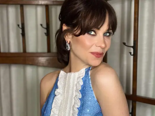 Zooey Deschanel in a sequin blue dress and bangs