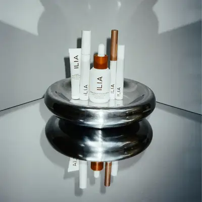 Ilia products on a silver tray