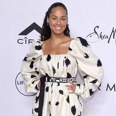 alicia keys in ponytail and black and white polkadot dress