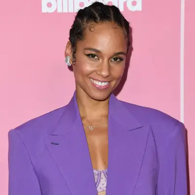 alicia keys in cornrows, silver diamond hoop earrings and purple suit