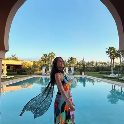 Olivia Rodrigo poses in a colorful halter dress while on vacation in Morocco.