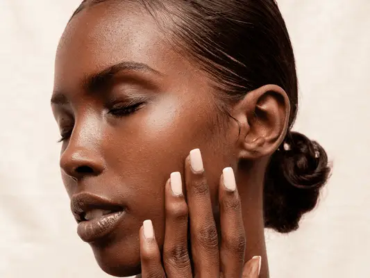 black woman model touching her face