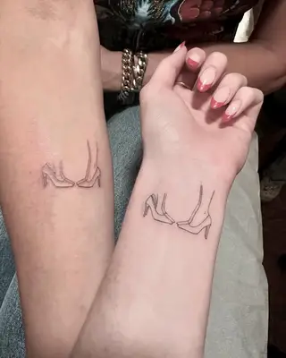 A photo of Brooke Shields and her daughters matching tattoos that illustrate a pair of two stilettos