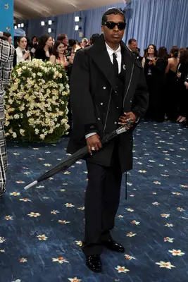 ASAP Rocky wears a black multi-piece suit and carries an umbrella to the 2025 Met Gala