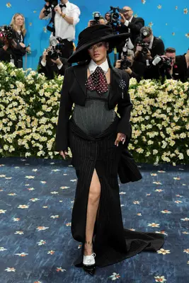 Rihanna wearing a three piece skirt suit and polka dot scarf at the 2025 Met Gala