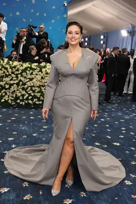 Ashley Graham wears a gray pinstriped tailored Boss gown to the 2025 Met Gala