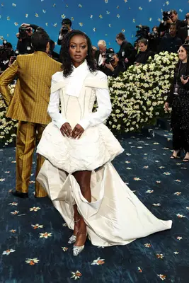 Danielle Deadwyler wears a corseted dress with train and tailored shirt to the 2025 Met Gala