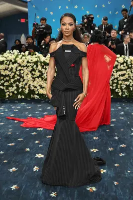 Zuri Hall wearing a black suit dress with pinstripes at the 2025 Met Gala