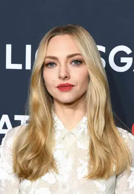 Amanda Seyfried poses with her signature wavy blonde hairstyle.