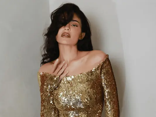 Kylie Jenner wearing a gold dress