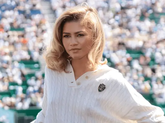 Zendaya wearing tennis sweater and curls
