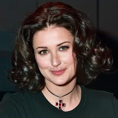 Demi Moore with short curly hair, big eyelashes and pink blush cheeks.