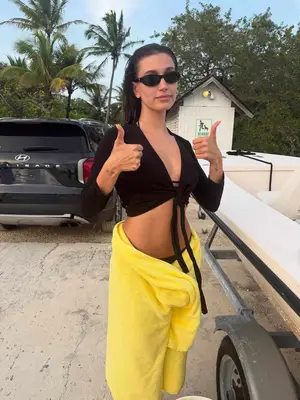 Hailey Bieber with her lemon drop nails and matching towel.