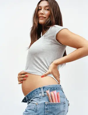 Hailey Bieber wearing orange nails.