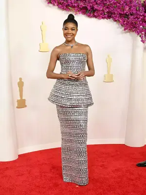 Gabrielle Union wears a silver structural Carolina Herrera gown and Tiffany jewelry to the 2024 Oscars