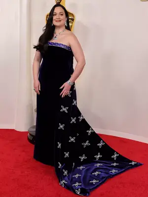 Lily Gladstone wears a black Gucci gown with white and purple embroidery to the 2024 Oscars