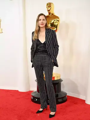 Justine Triet wears a sparkly pinstriped suit and satin black top to the 2024 Oscars