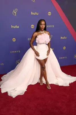 Aja Naomi King wears a pink minidress with floral ruffle detailing and dramatic train to the 2024 Emmy Awards 