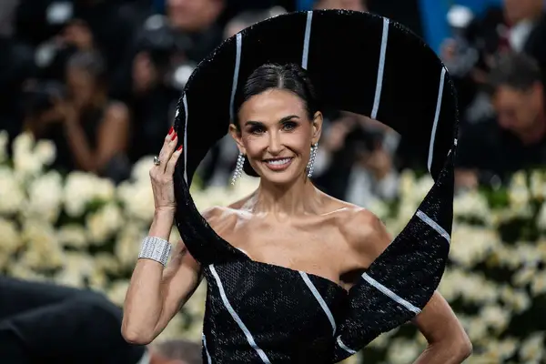 Demi Moore poses at the 2025 Met Gala to show off her red manicure.