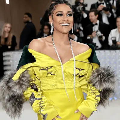 LaLa Anthony with a high ponytail, headband, and tiny sunglasses