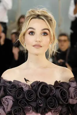 Chloe Fineman with a wispy updo and pink makeup