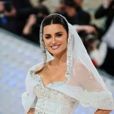Penelope Cruz at the 2023 Met Gala with a mantilla veil and sleek, shiny hair