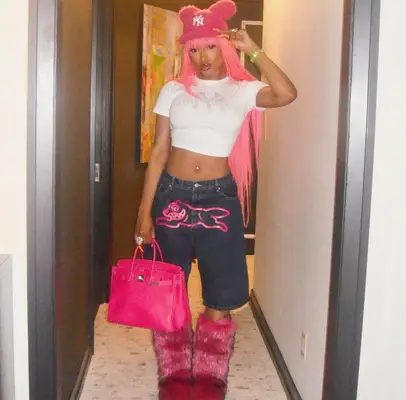 Megan Thee Stallion shows off her long hot pink hair.