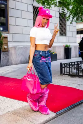 Megan Thee Stallion throws up a peace sign for the paparazzi.