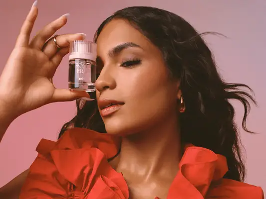 Monet McMichael holding Rose Era perfume