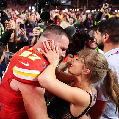 Taylor Swift kissing Travis Kelce after his Super Bowl win with a milky white manicure and ponytail
