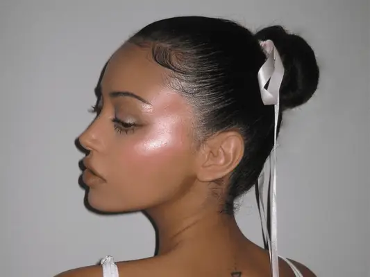 Woman with bow in her hair, blush and highlighter