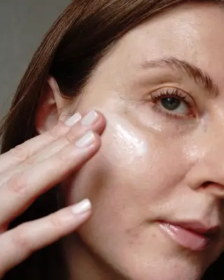 Woman swiping product on her cheek