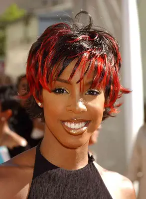 Kelly Rowland attends award show in LA wearing a haulter top and red highlights in her pixie