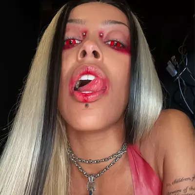 Doja Cat with red contacts and marbled hair 