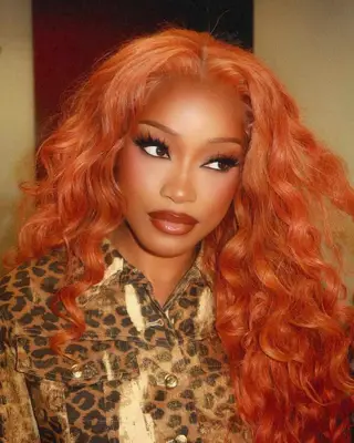 A close up of Keke Palmer with bright red, long, curly hair.