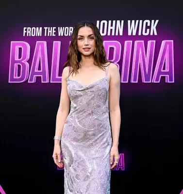 Ana de Armas poses with her arms near her side to show off her ballerina chrome manicure.