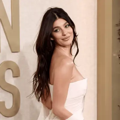camila marrone with long hair and blush dress at golden globes